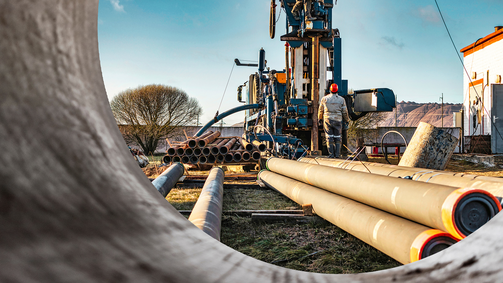 Image of a geothermal rig and a person controlling it